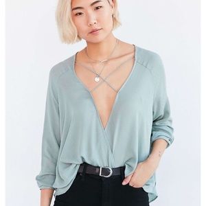 Light blue blouse with straps across chest
